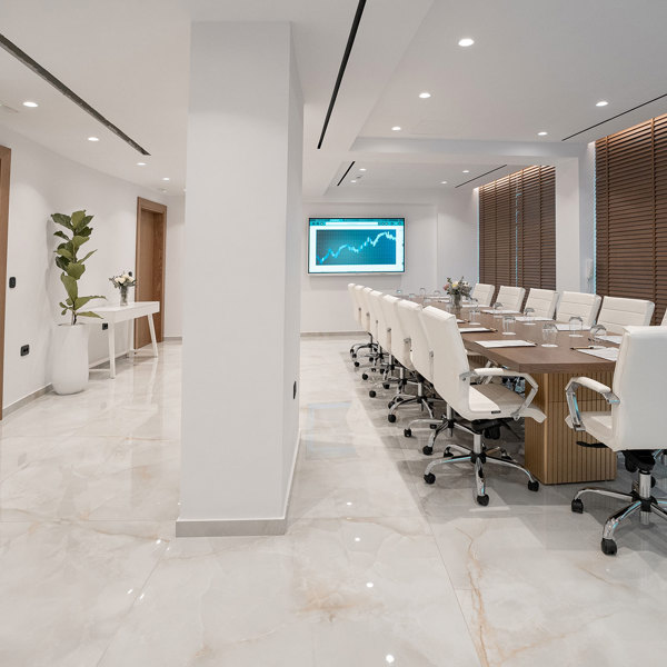 Ethereal White Resort Heraklion Meeting Room room with large wooden table and white office chairs