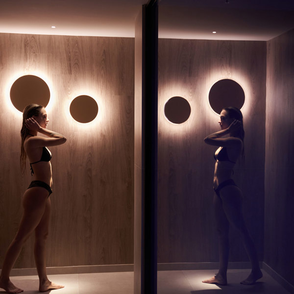 Mirrored image of a Ethereal White Resort Heraklion Spa visitor at the corridor