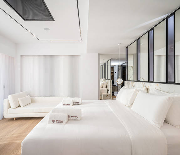Ethereal White Resort Heraklion Luxury Suite double bed, couch and amenities